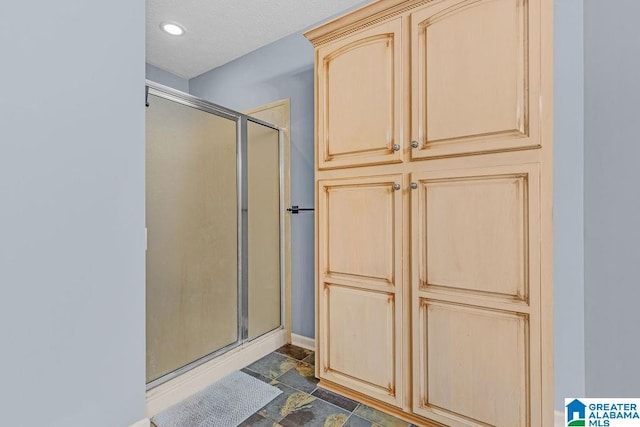 bathroom featuring a shower with shower door