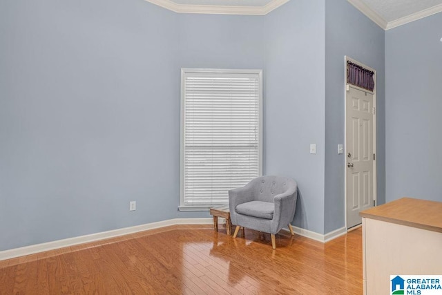 sitting room featuring ornamental molding and light hardwood / wood-style floors