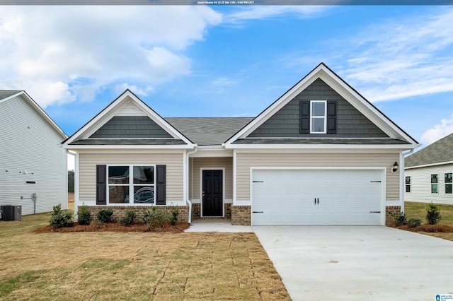 craftsman-style house featuring central AC unit, a garage, brick siding, a front lawn, and driveway