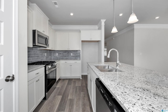 kitchen featuring white cabinetry, stainless steel appliances, light stone countertops, and sink