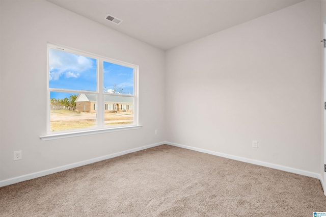 spare room featuring visible vents, baseboards, and carpet floors