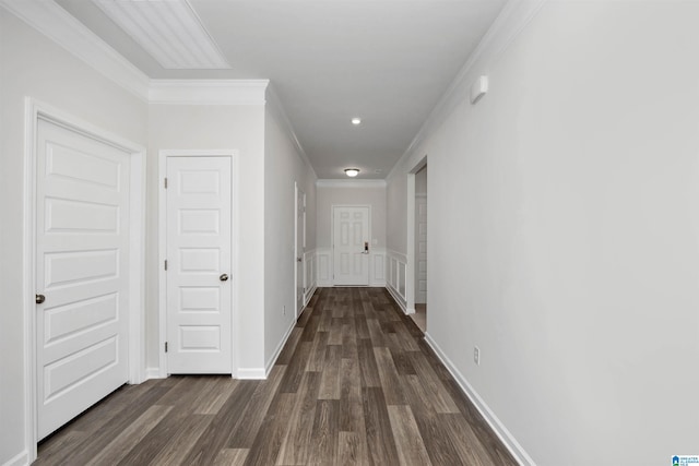 hall featuring ornamental molding and dark hardwood / wood-style floors