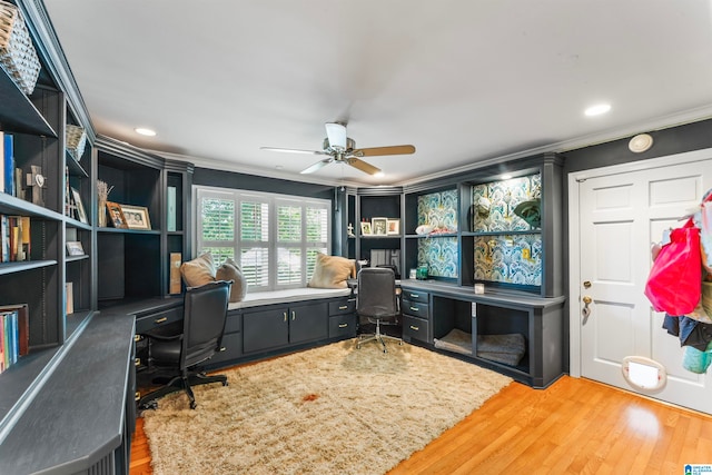 office area featuring wood-type flooring, ornamental molding, and ceiling fan