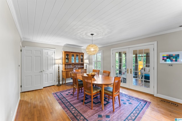 dining space with french doors, wooden ceiling, ornamental molding, and light wood-type flooring