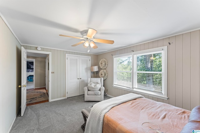 carpeted bedroom with a closet, crown molding, and ceiling fan