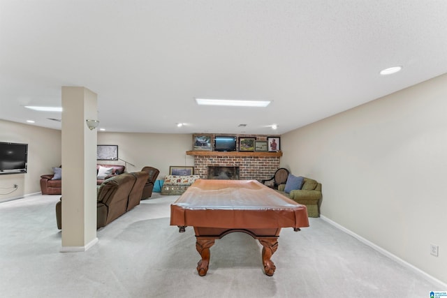 recreation room with a fireplace, light colored carpet, and pool table