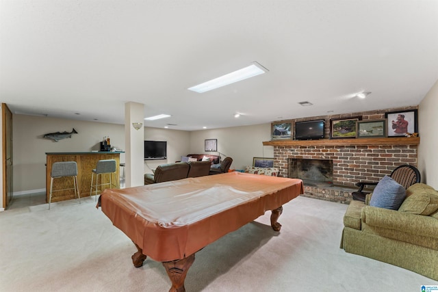 game room featuring pool table, a brick fireplace, light colored carpet, and bar area