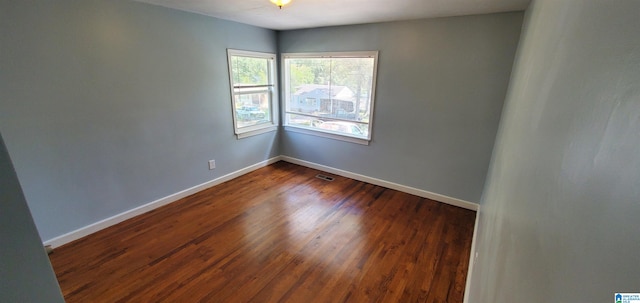 spare room with dark hardwood / wood-style flooring