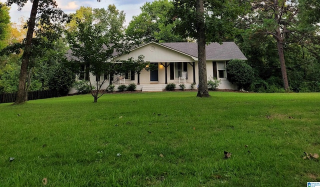 single story home with a porch and a front lawn