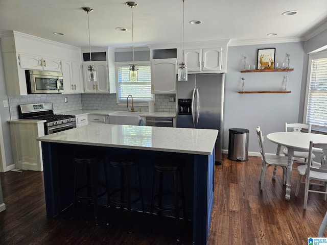 kitchen featuring sink, a center island, stainless steel appliances, and white cabinets