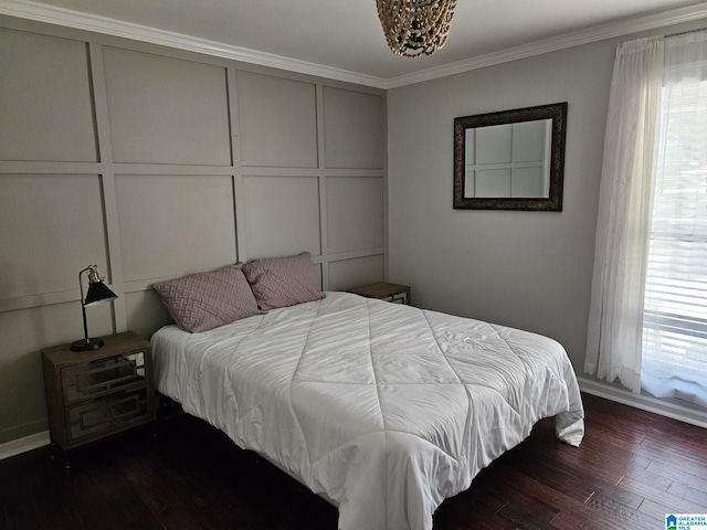 bedroom featuring ornamental molding and dark wood-type flooring