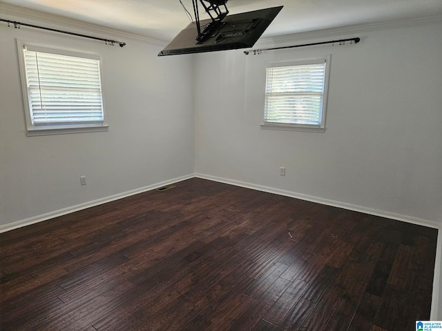 unfurnished room featuring ornamental molding and hardwood / wood-style flooring