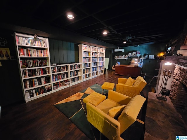 cinema room featuring wooden walls and hardwood / wood-style floors