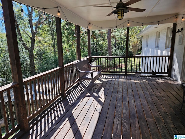 wooden deck featuring ceiling fan