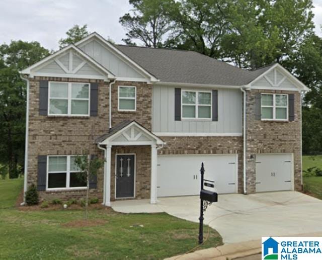 view of front of property with a front lawn and a garage