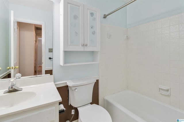 full bathroom with tiled shower / bath combo, vanity, and toilet