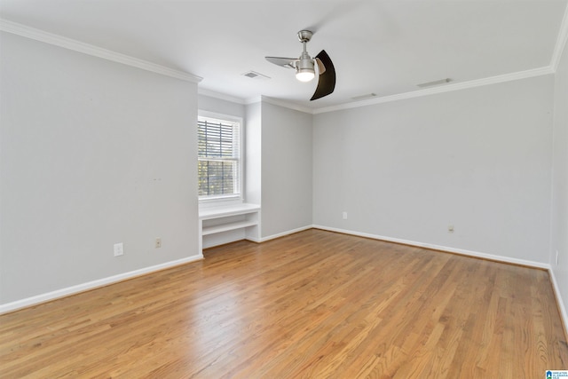 unfurnished room featuring ceiling fan, light wood-type flooring, and ornamental molding