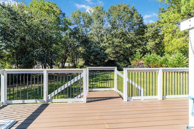 wooden terrace with a lawn