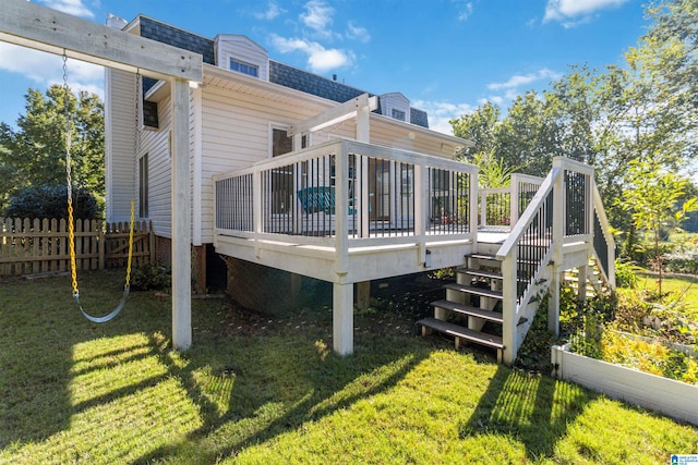 rear view of property with a deck and a lawn