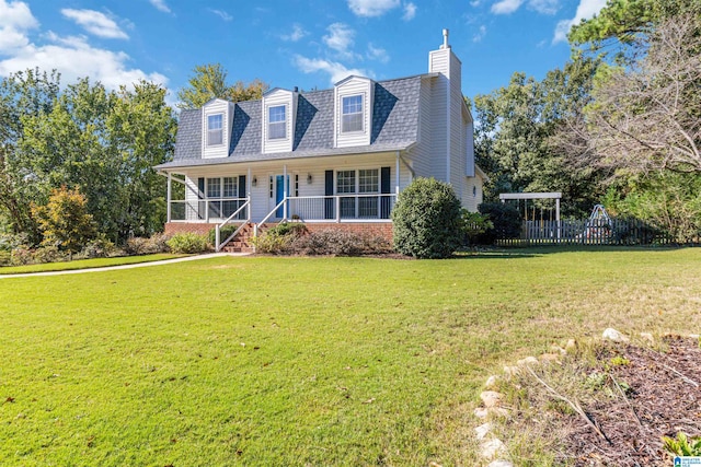 new england style home featuring a front yard and covered porch