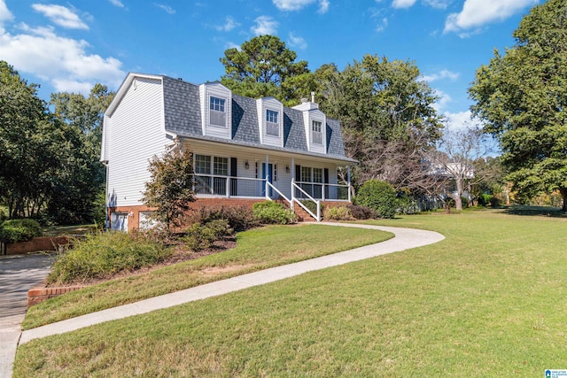 new england style home featuring a porch and a front lawn