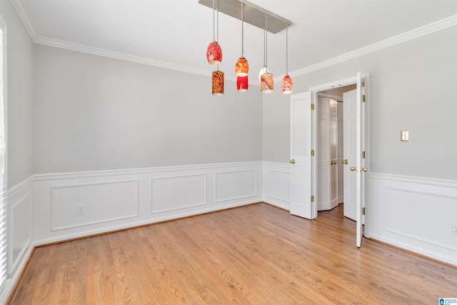 spare room with ornamental molding and hardwood / wood-style flooring