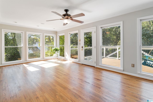 unfurnished sunroom featuring ceiling fan