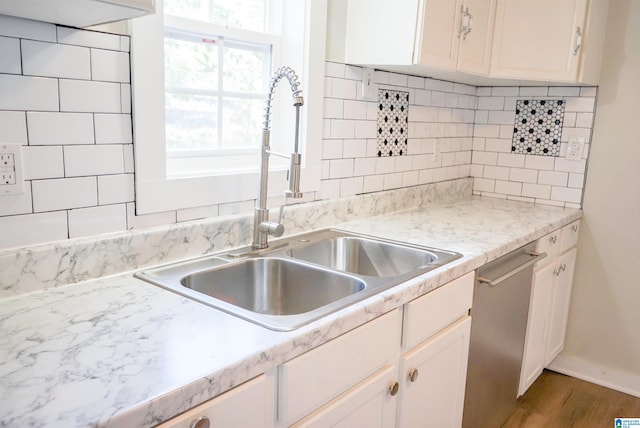 kitchen featuring white cabinets and sink