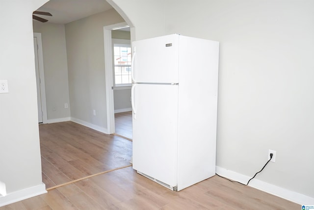 interior space with ceiling fan, light wood-type flooring, and white fridge