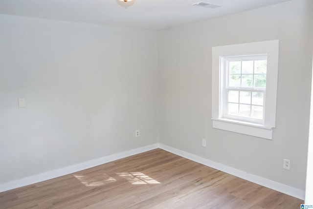 unfurnished room with light hardwood / wood-style floors