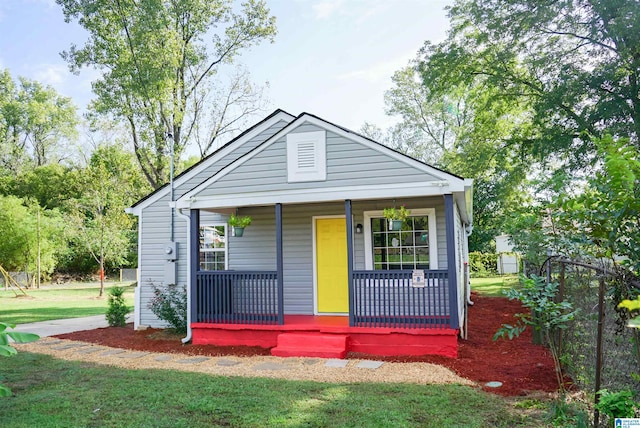 bungalow with a front yard and covered porch