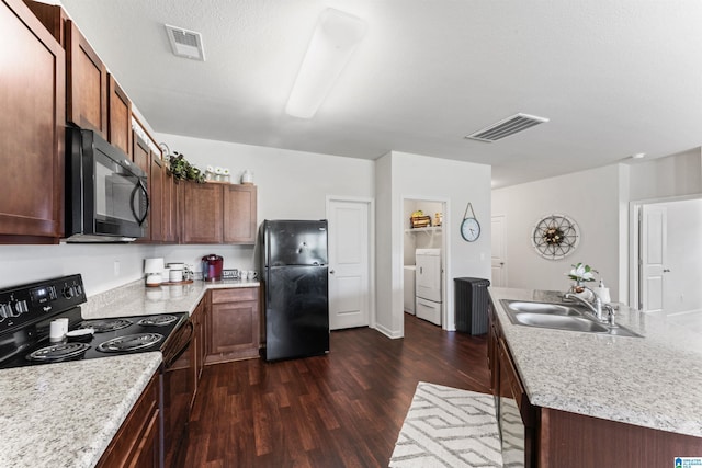 kitchen featuring black appliances, a sink, dark wood finished floors, and light countertops