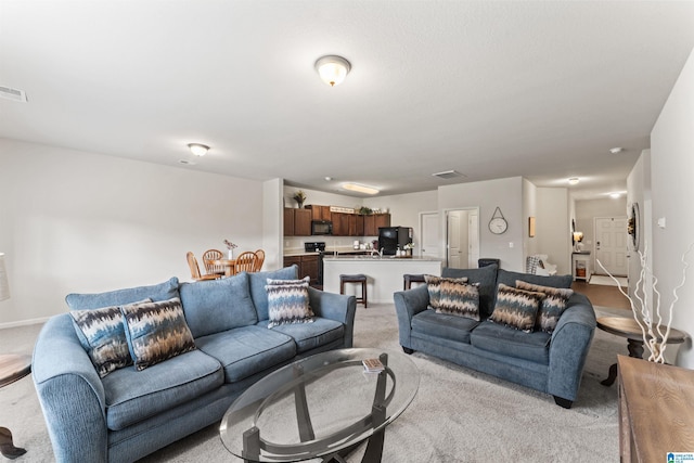 living area with light colored carpet
