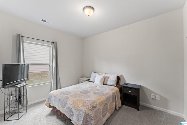 bedroom featuring carpet and baseboards