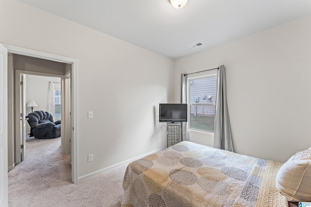 carpeted bedroom with baseboards