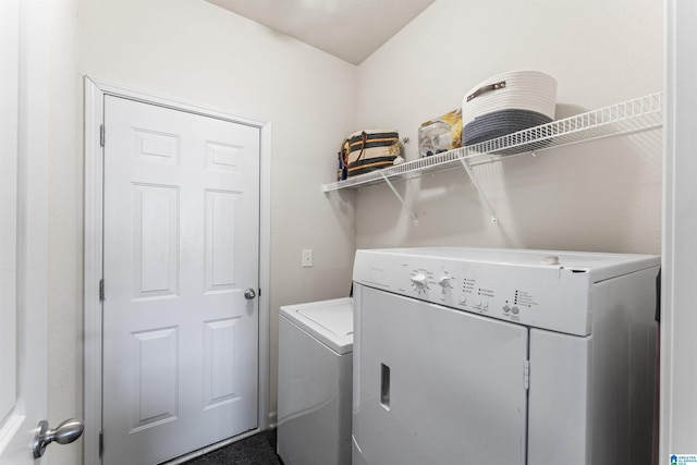 clothes washing area featuring washer and dryer
