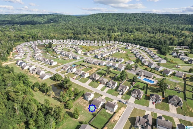 aerial overview of property's location featuring a heavily wooded area and nearby suburban area