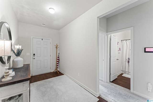 carpeted entryway with baseboards