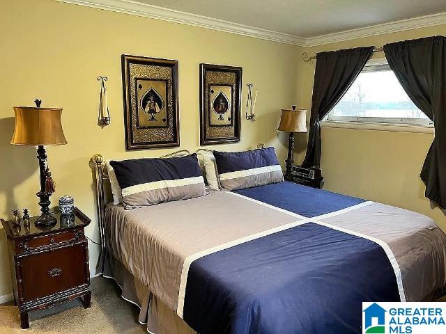 carpeted bedroom with crown molding