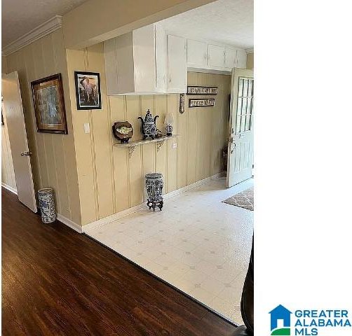 interior space featuring ornamental molding and dark hardwood / wood-style flooring