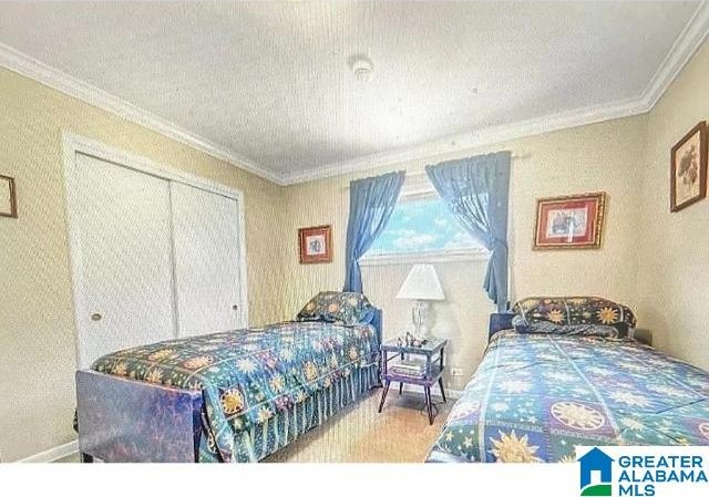 bedroom featuring a closet and crown molding