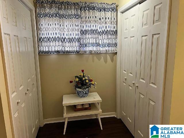 doorway with dark hardwood / wood-style floors