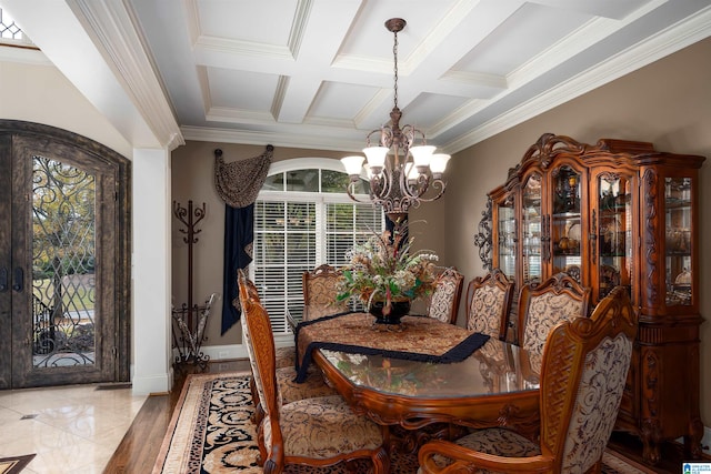 tiled dining room featuring beam ceiling, ornamental molding, coffered ceiling, and a notable chandelier