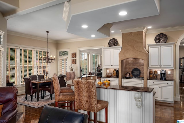 kitchen with tasteful backsplash, a healthy amount of sunlight, and dark wood-type flooring