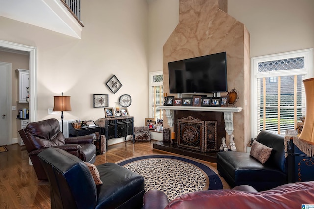 living room with a high ceiling and hardwood / wood-style flooring