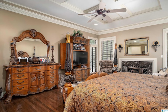 bedroom with dark wood-type flooring, ceiling fan, a raised ceiling, and ornamental molding