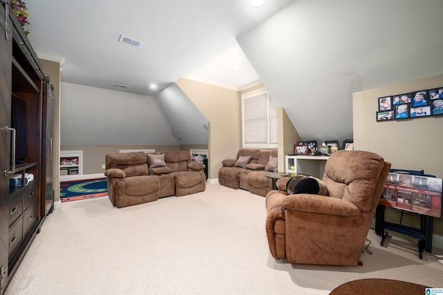 carpeted cinema room with ornamental molding and vaulted ceiling