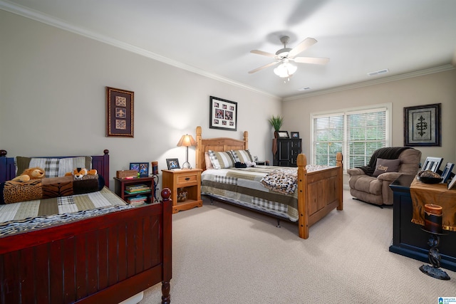 carpeted bedroom featuring crown molding and ceiling fan