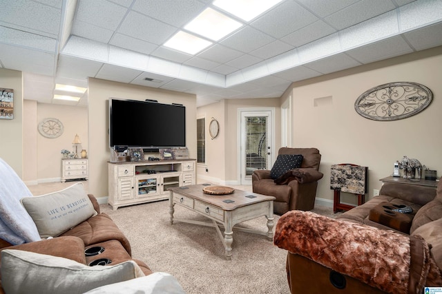 living room with a paneled ceiling and carpet