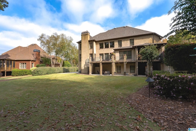 rear view of property featuring a yard